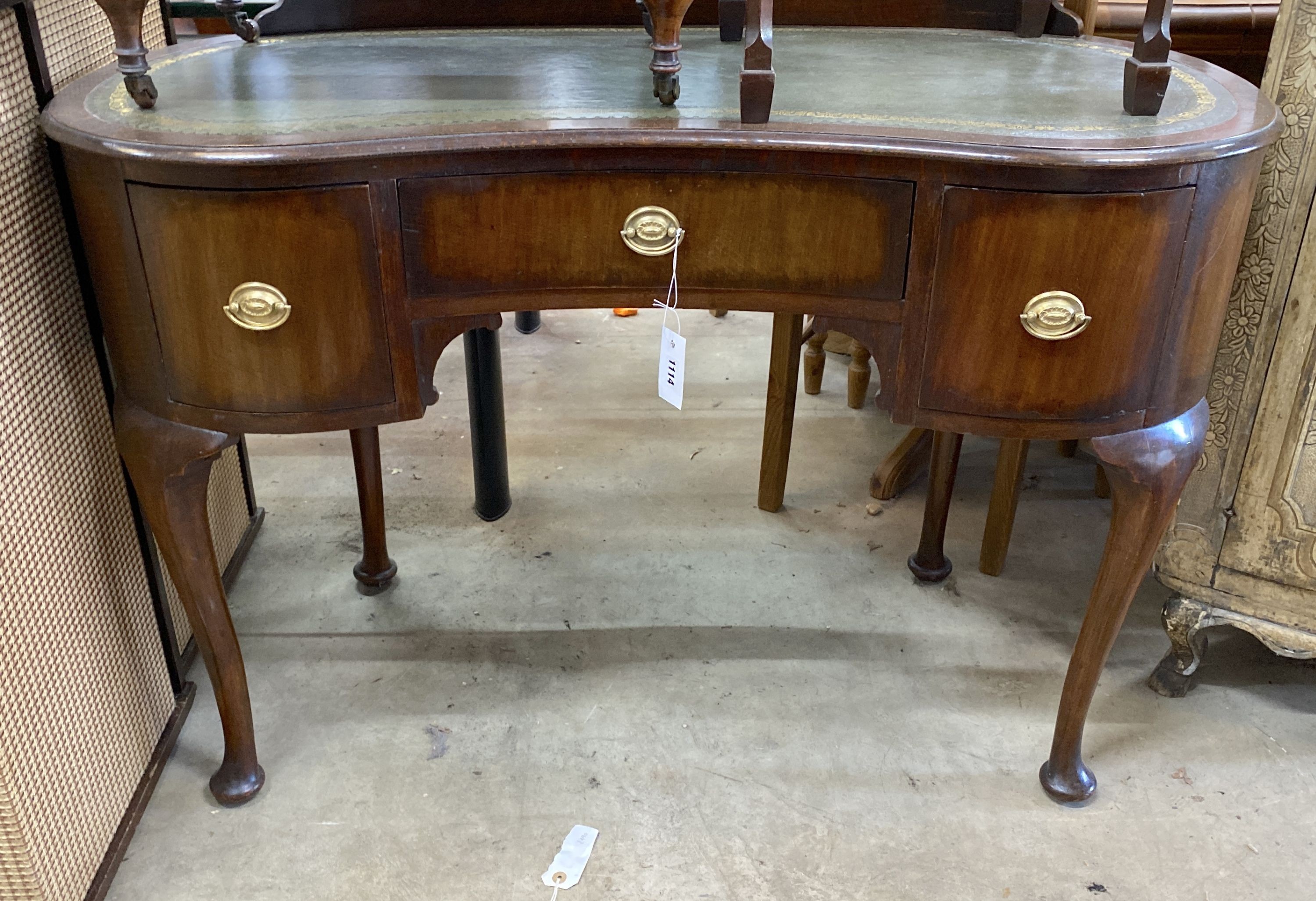 A 1920's kidney shaped writing table, width 110cm, depth 50cm, height 78cm